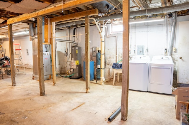 basement featuring water heater and independent washer and dryer