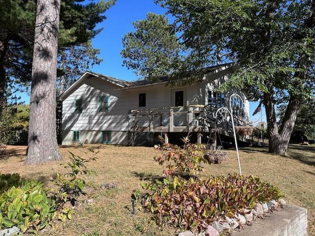 back of house with a yard and a wooden deck