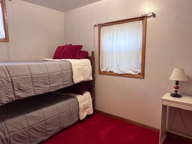 carpeted bedroom featuring baseboards