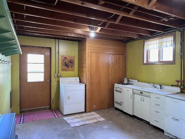 laundry area with washer / clothes dryer, a healthy amount of sunlight, and a sink