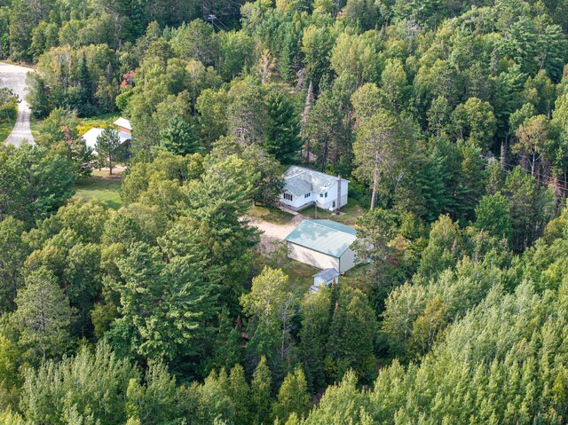 drone / aerial view featuring a wooded view