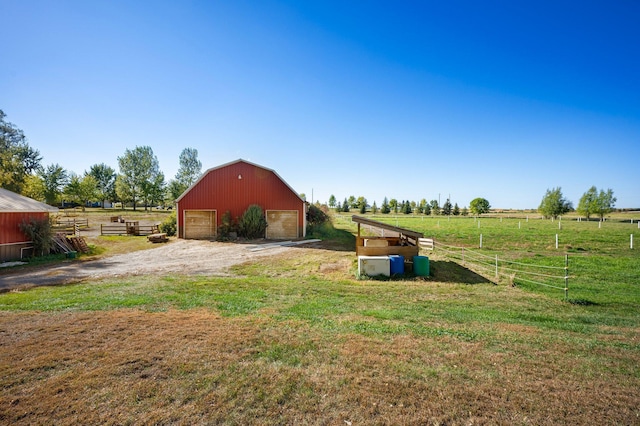 view of yard with a rural view and an outdoor structure