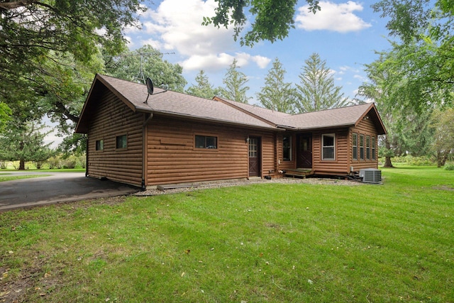 exterior space with a front yard and central AC