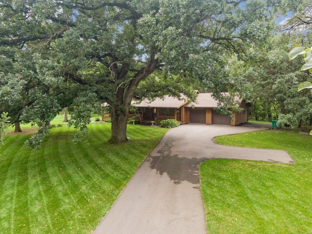 view of front of home featuring a garage and a front lawn