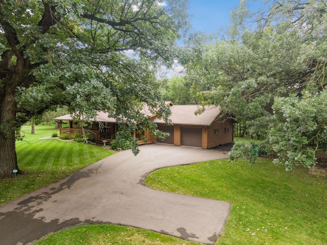 view of front of property with a front lawn and a garage