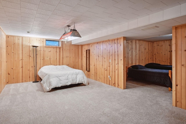 carpeted bedroom with wooden walls