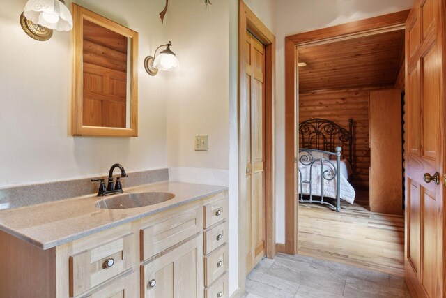 bathroom featuring vanity, rustic walls, hardwood / wood-style floors, and wood ceiling