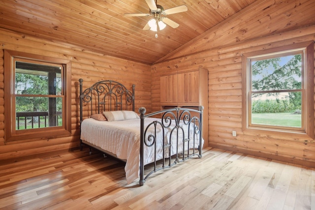 bedroom with light wood-type flooring, ceiling fan, wood ceiling, rustic walls, and vaulted ceiling