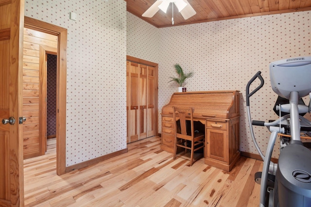 office area featuring ceiling fan, vaulted ceiling with skylight, wood ceiling, and light wood-type flooring