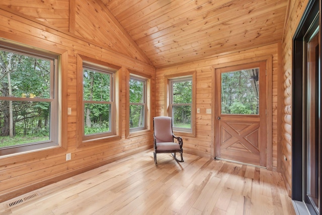 unfurnished sunroom featuring wooden ceiling, vaulted ceiling, and a healthy amount of sunlight