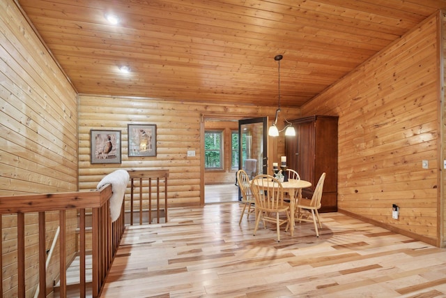 dining area with wood ceiling, a chandelier, and light hardwood / wood-style floors