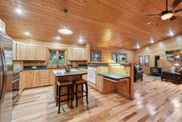 kitchen with white oven, wooden ceiling, light hardwood / wood-style flooring, and a center island