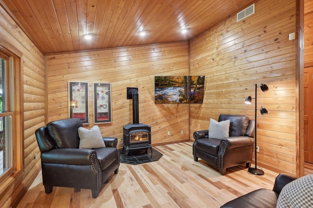 living area featuring wood walls, wood ceiling, and light hardwood / wood-style floors