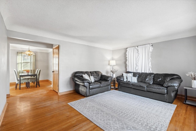 living room featuring wood-type flooring and a textured ceiling