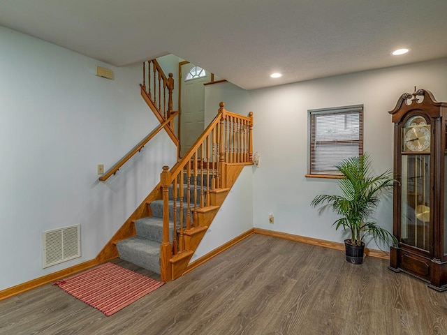 staircase featuring hardwood / wood-style floors