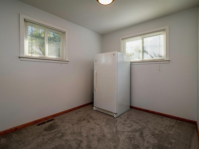 laundry area with light carpet, visible vents, and baseboards
