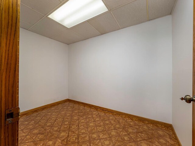 unfurnished room featuring a paneled ceiling