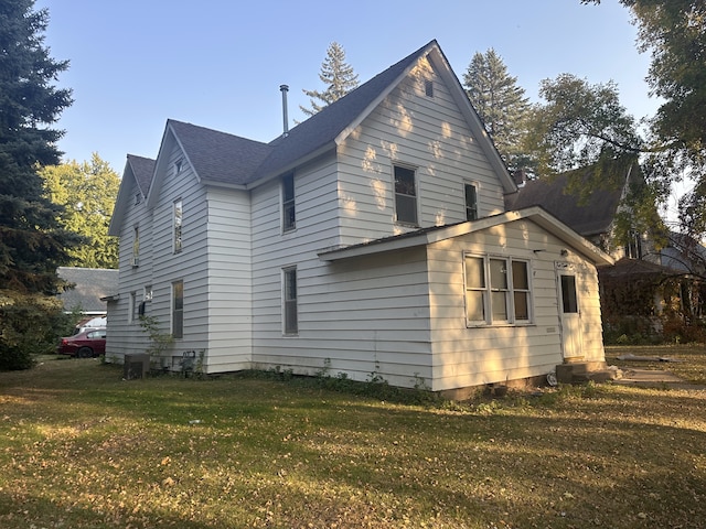 view of home's exterior with a lawn