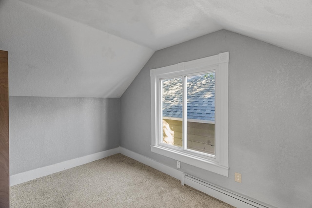 bonus room with a textured ceiling, a baseboard radiator, vaulted ceiling, and carpet flooring