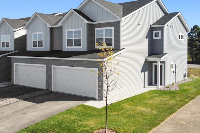 view of front facade with a garage and a front lawn