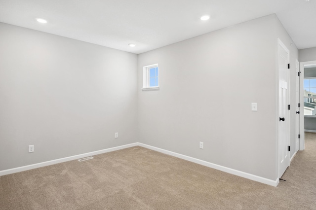 carpeted spare room featuring a wealth of natural light