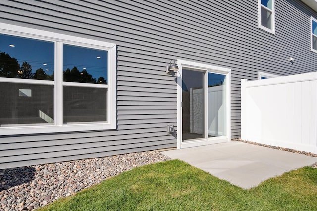 view of side of home with a patio area