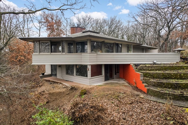 back of house with a sunroom