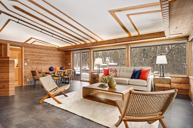 living room featuring visible vents and wooden walls