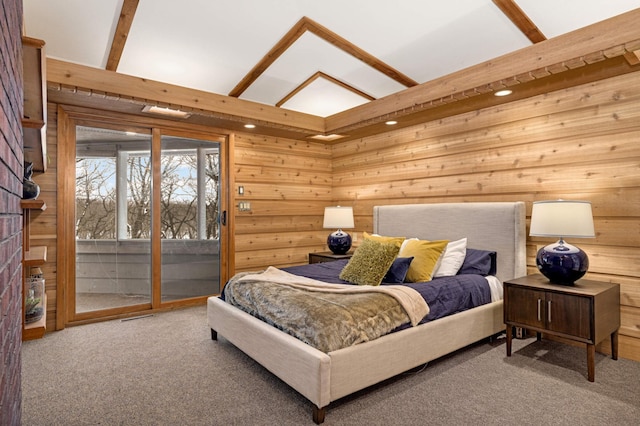 bedroom with wood walls, carpet, and access to exterior