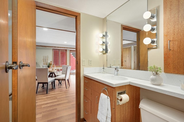 bathroom with vanity, toilet, and wood finished floors