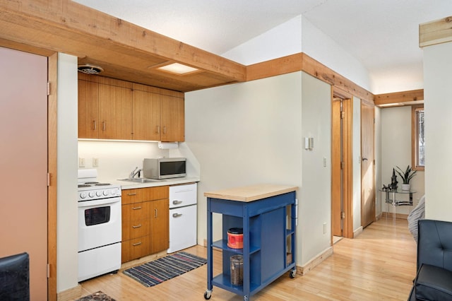 kitchen with white range with electric stovetop, stainless steel microwave, light countertops, light wood-type flooring, and open shelves