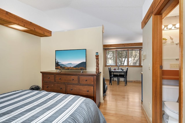 bedroom with light wood-style flooring and baseboards