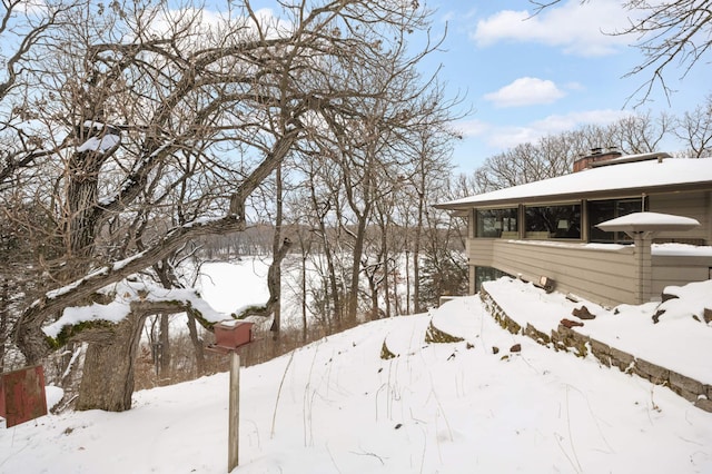 snowy yard with a garage