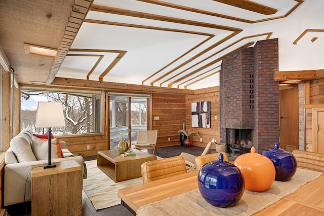 living area with lofted ceiling, wooden walls, and a fireplace