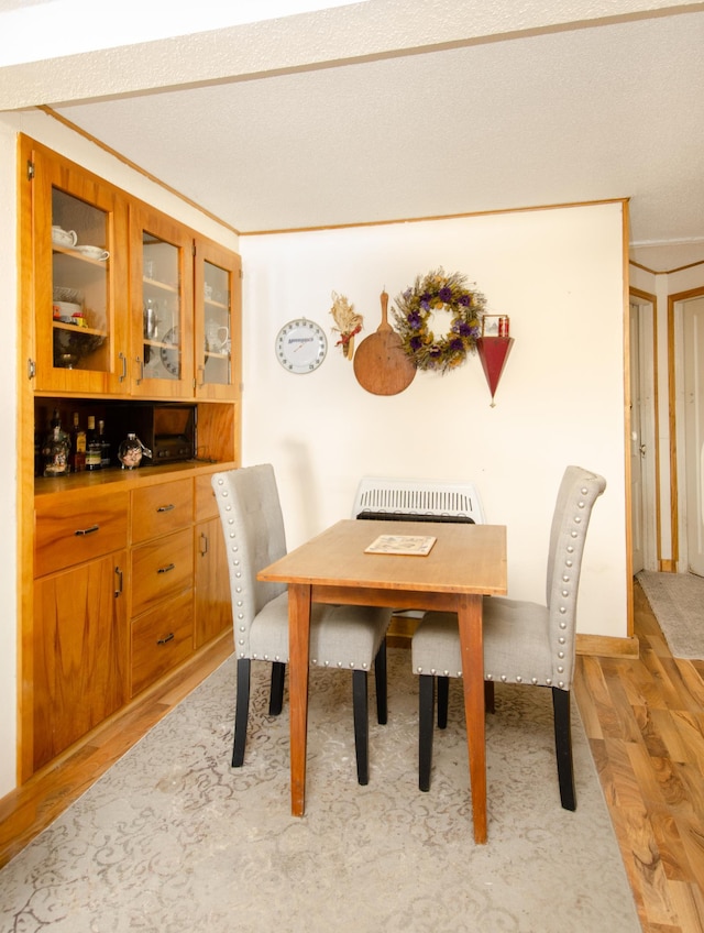 dining room featuring light hardwood / wood-style floors and ornamental molding