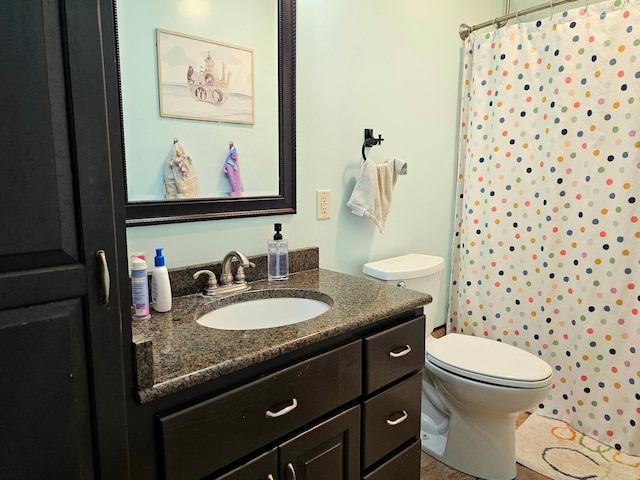 bathroom featuring vanity, toilet, and a shower with shower curtain