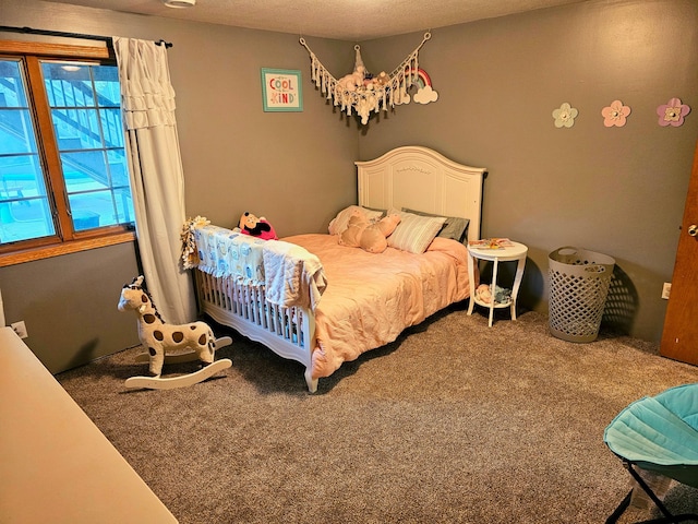 bedroom with carpet and a textured ceiling