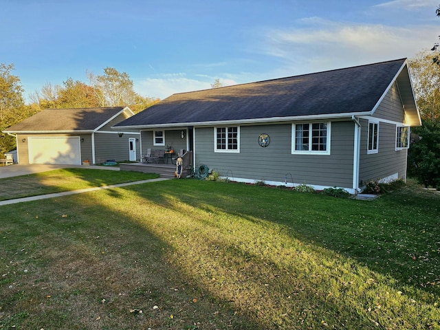 single story home with a wooden deck, a front yard, and a garage