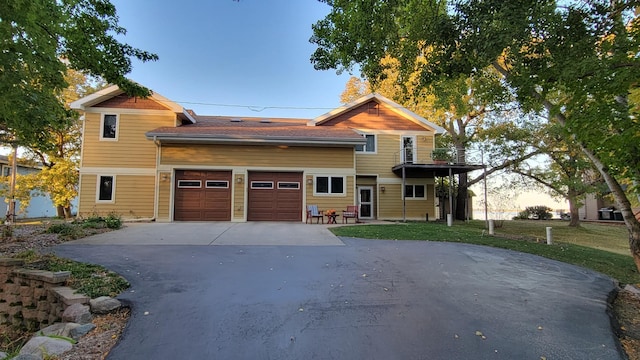 view of front of home featuring a garage and a lawn