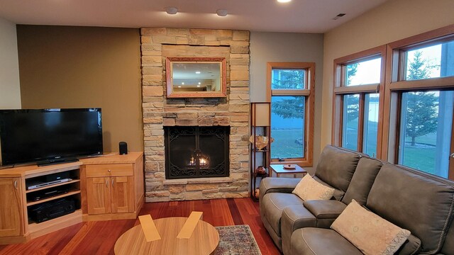 living room featuring dark hardwood / wood-style flooring and a fireplace