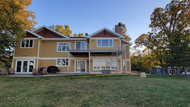 back of property featuring a patio, french doors, and a lawn