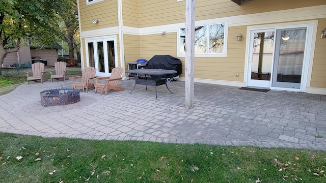 view of patio with area for grilling and a fire pit