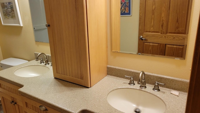 bathroom featuring vanity and toilet