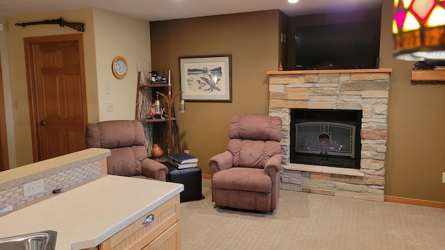 carpeted living room with sink and a fireplace