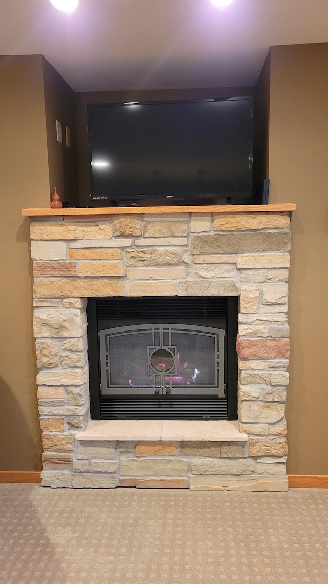 details with a fireplace and carpet flooring