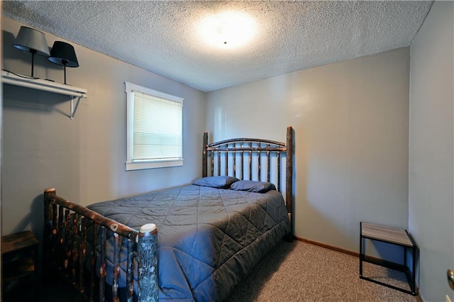 bedroom featuring a textured ceiling and carpet