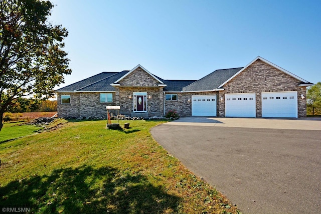 44154 Skogman Lake Rd, Fish Lake Twp, MN 55008 - view of front of home with stone siding, a garage, a front lawn, a shingled roof, and driveway