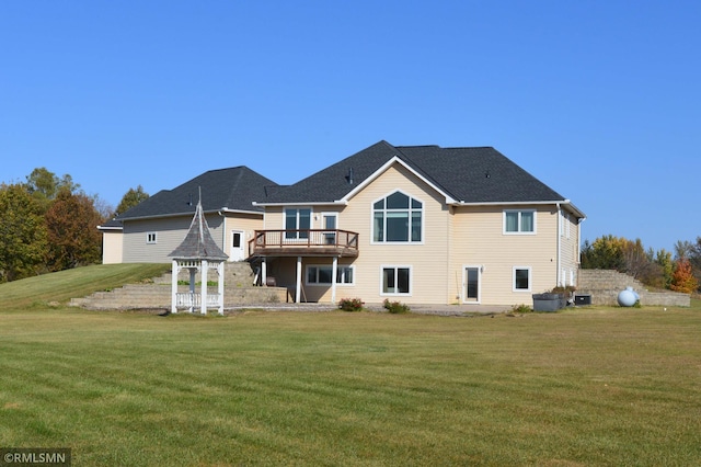 back of property with a gazebo and a lawn