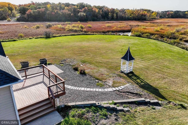 view of yard with a wooden deck and a rural view