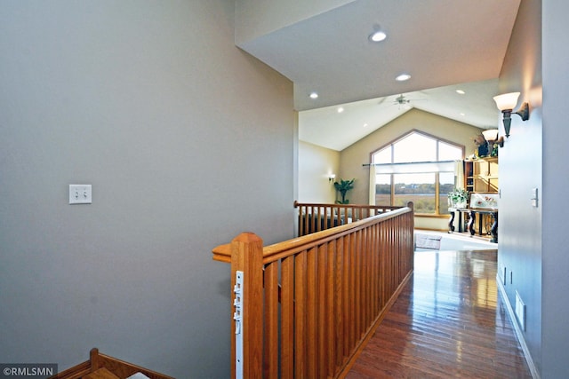 hallway featuring vaulted ceiling and dark hardwood / wood-style floors